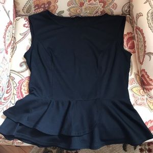 Sleeveless black peplum top with ruffled bottom